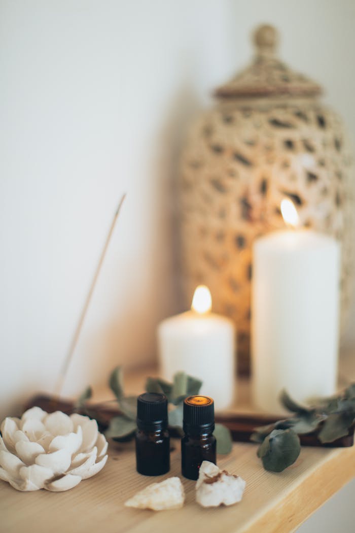 Offerings Tranquil scene featuring essential oils, candles, and eucalyptus for a relaxing atmosphere.